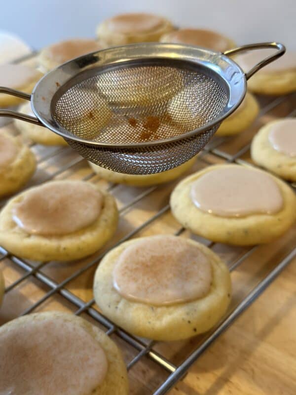 dusting taylor swift chai cookies with cinnamon
