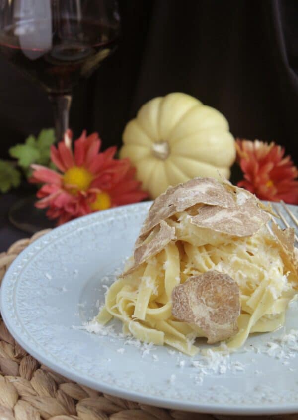 truffle pasta with mini pumpkin and glass of wine