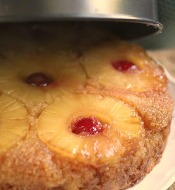 inverting pineapple upside down cake onto a plate