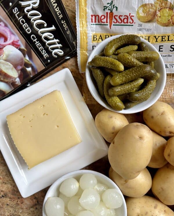 raclette, cornichons, potatoes and onions