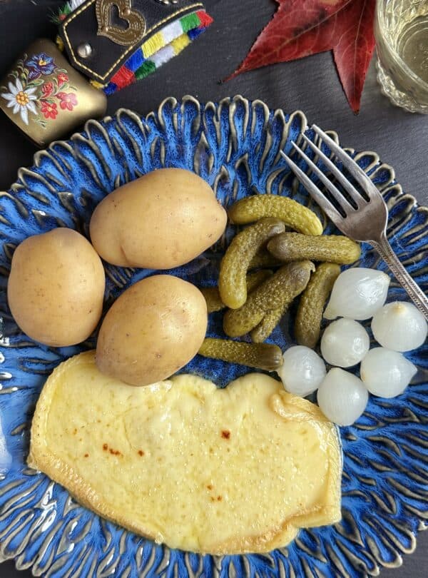 overhead raclette with cornichons and pickled onions