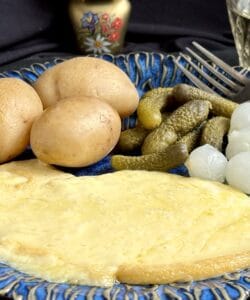 cheese plate with potatoes and pickles