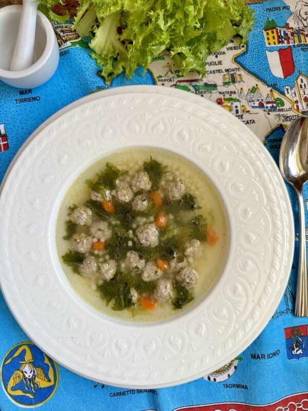 Italian wedding soup overhead on map of Italy tea towel