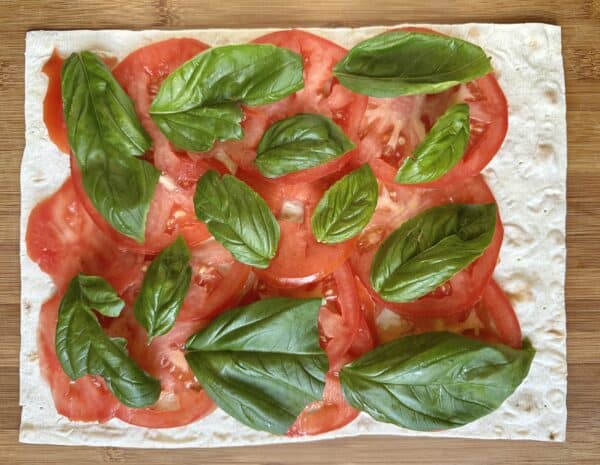 making Caprese pinwheel sandwiches