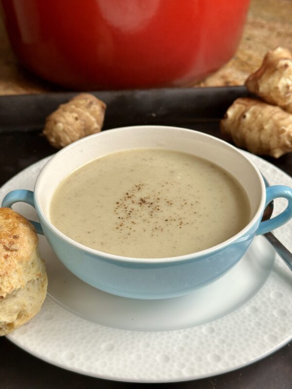 sunchoke soup with scone on plate