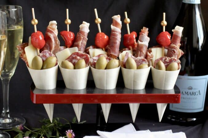 charcuterie cups in a stand with Prosecco