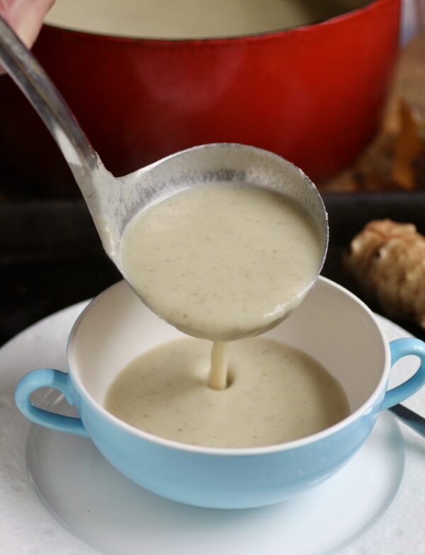 ladling soup into bowl