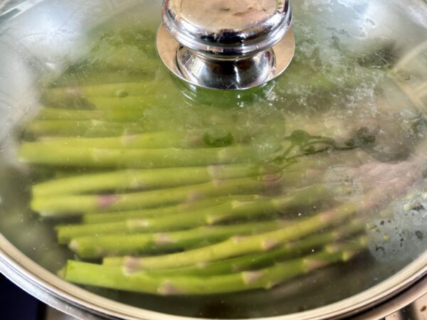 asparagus cooking in a pan