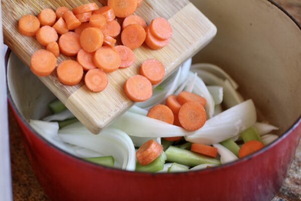 adding vegetables to the pot