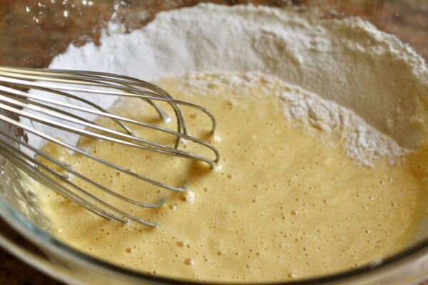 whisking egg into flour