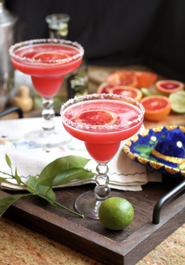 blood orange margarita on tray with lime for cinco de mayo
