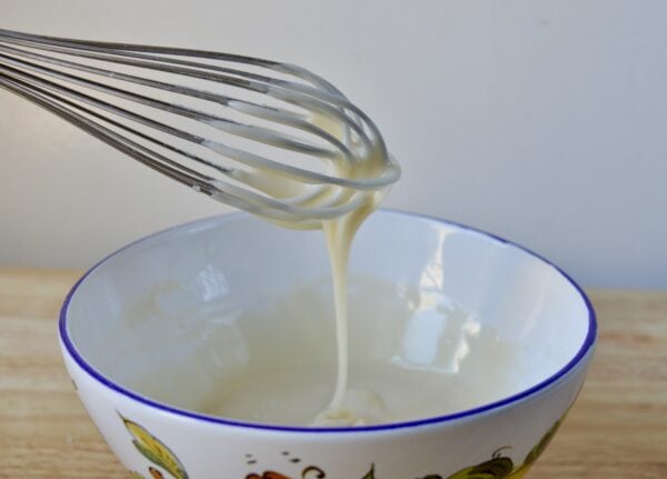 bergamot icing dripping off whisk