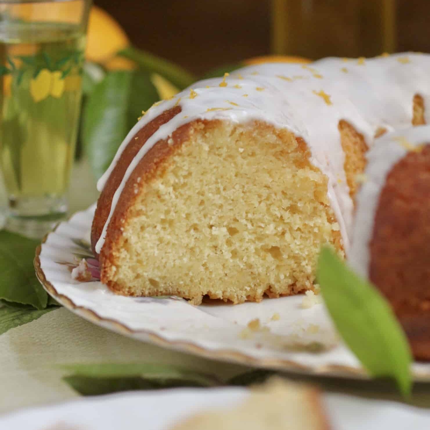 Meyer lemon bundt cake cut open with glass of limoncello
