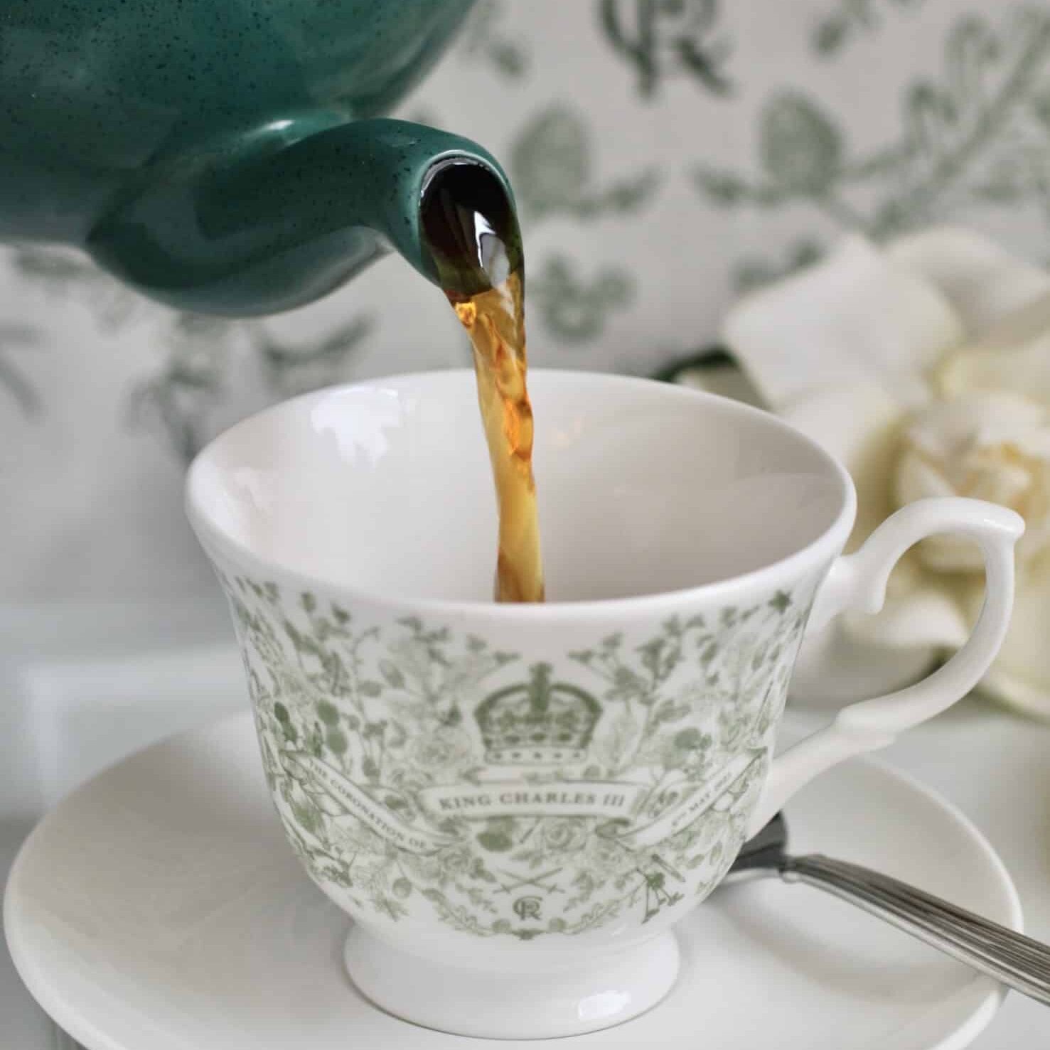 pouring loose leaf British tea into a Coronation cup