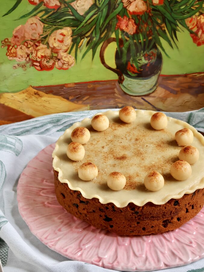 Simnel cake with art behind