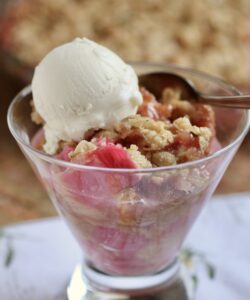 Rhubarb crisp in glass with scoop of vanilla ice cream