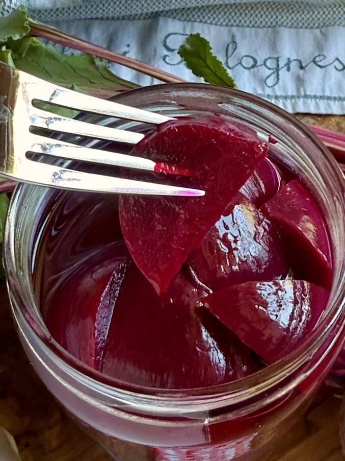 pickled beet on a fork from a jar