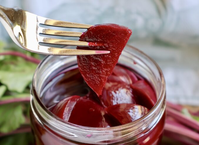 pickled beet on a fork from a jar