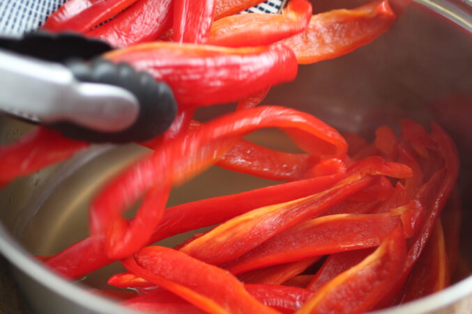 adding sweet peppers to vinegar