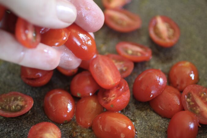 adding tomatoes to a pan