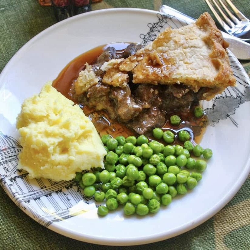 steak pie dinner with mash and peas