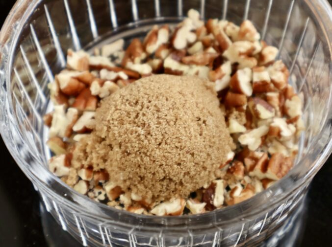 topping with brown sugar and nuts for blueberry crumble muffins