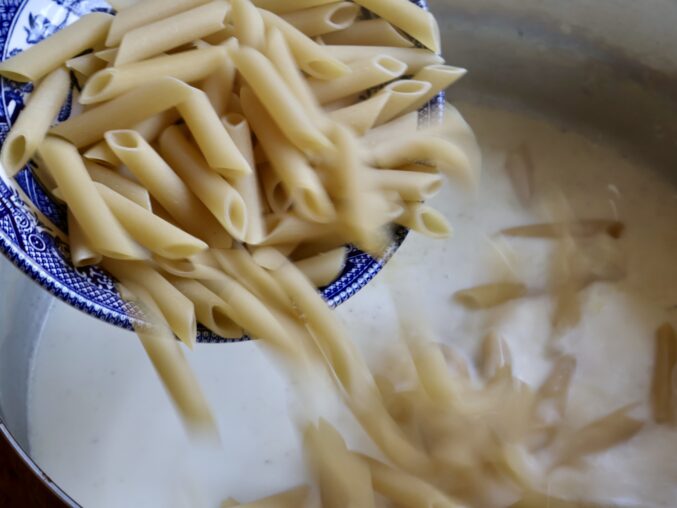 adding pasta