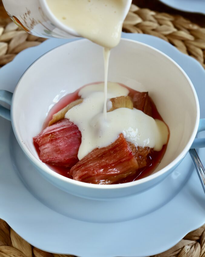 pouring custard over rhubarb