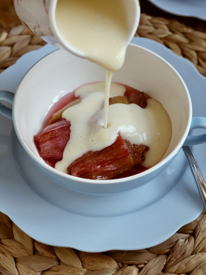 pouring custard onto rhubarb