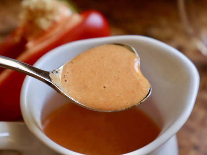 red bell pepper sauce in a heart spoon