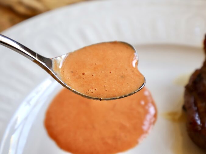 red bell pepper sauce in a heart spoon