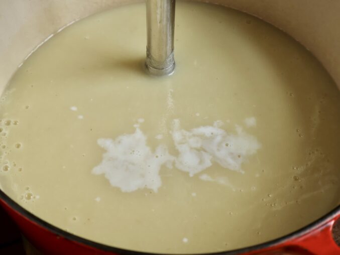 adding half and half to parsnip soup