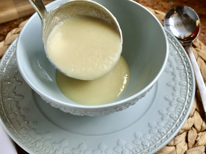 ladling parsnip soup into bowl
