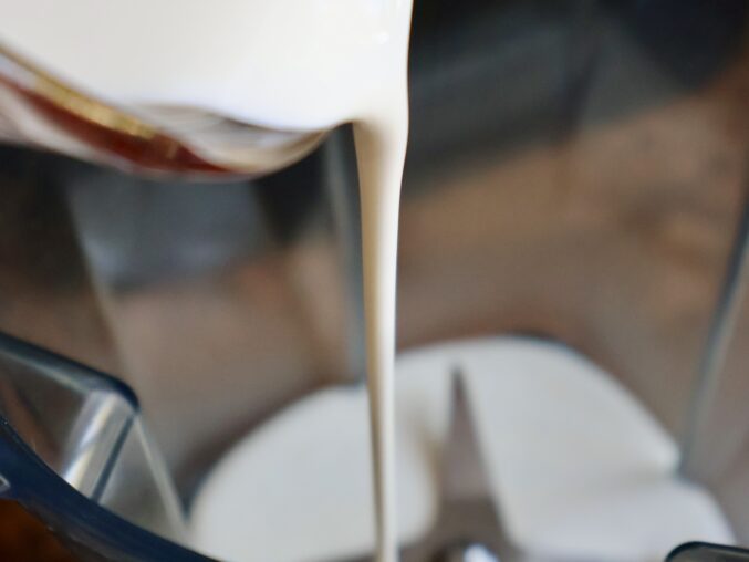 adding cream to blender