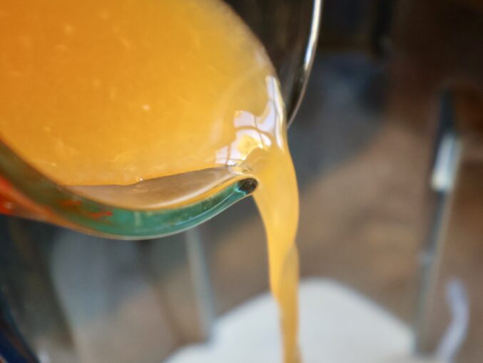 pouring tangerine juice into blender