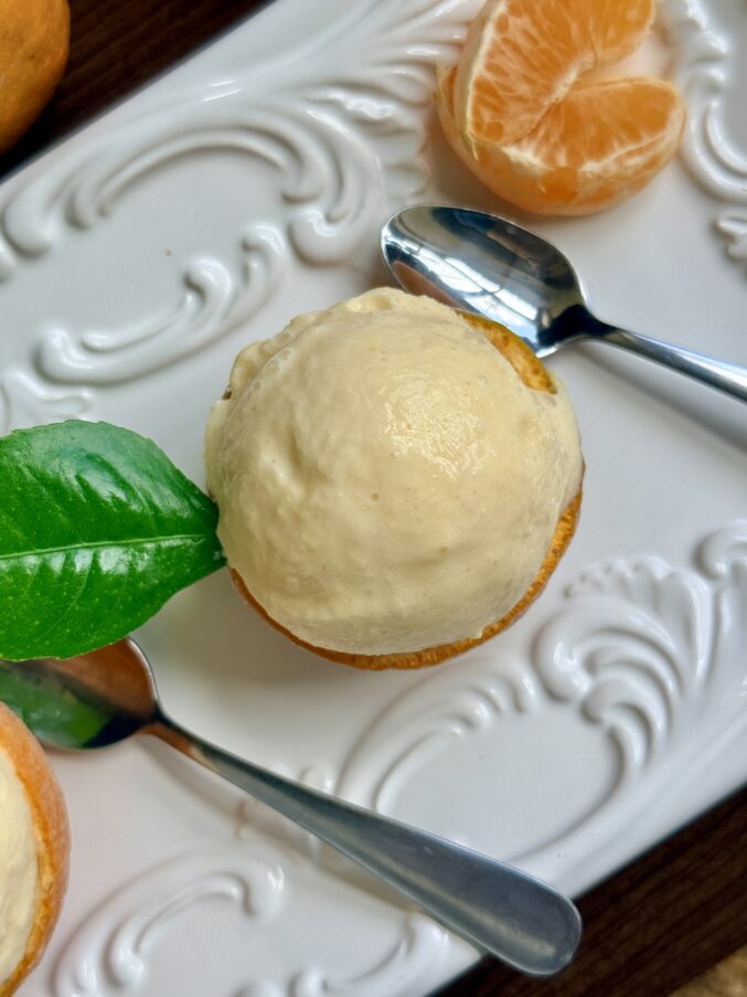 tangerine ice cream in a frozen shell overhead