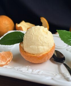 tangerine ice cream in a frozen shell with leaf