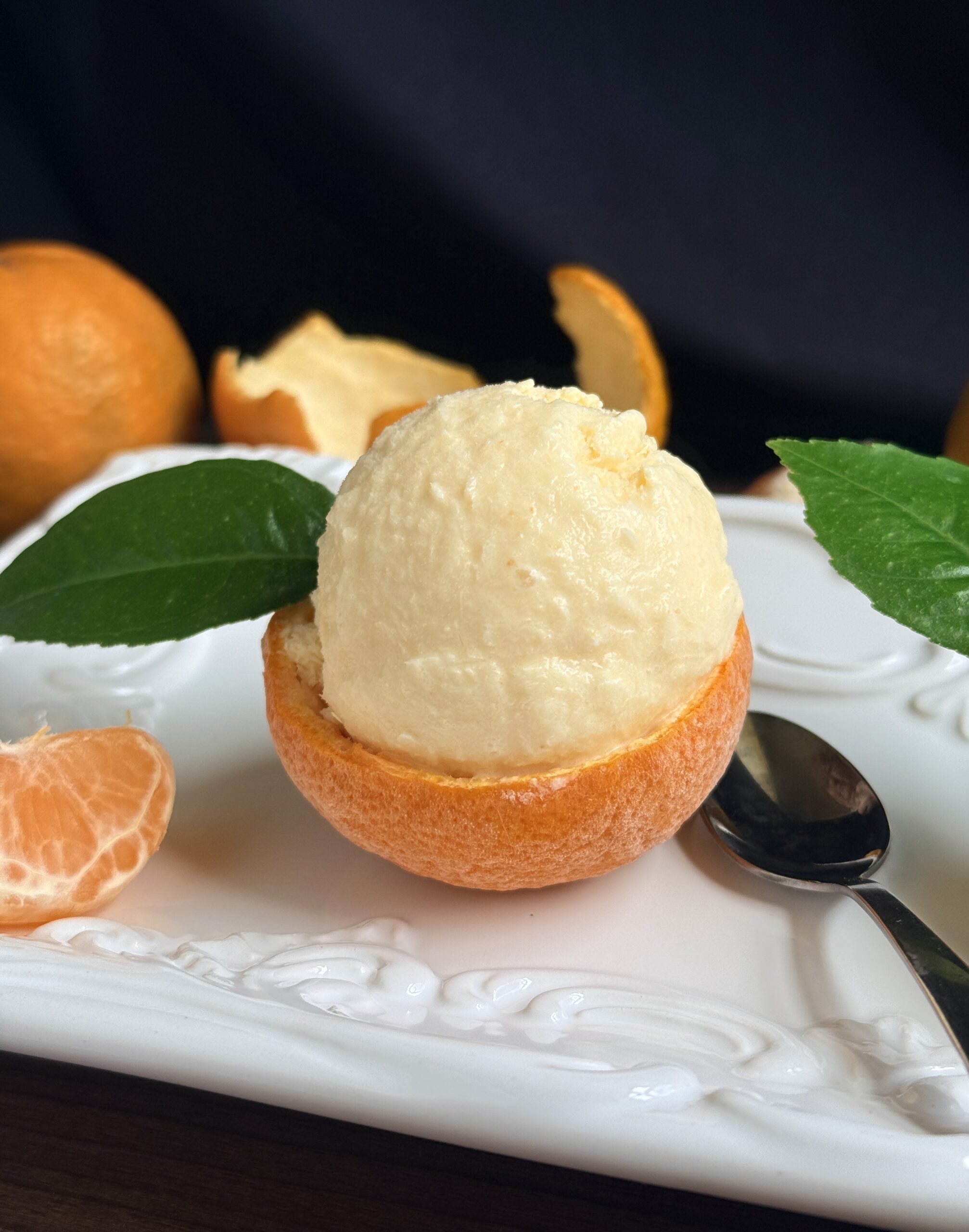 tangerine ice cream in a frozen shell with leaf