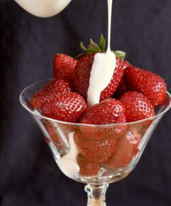 pouring cream onto fruit