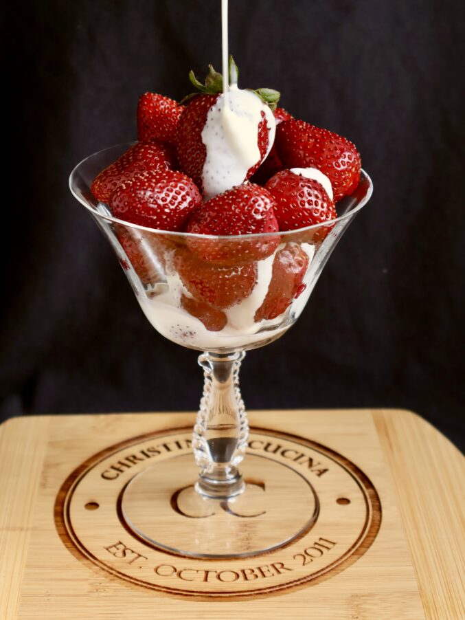 thick dairy dripping onto red fruit
