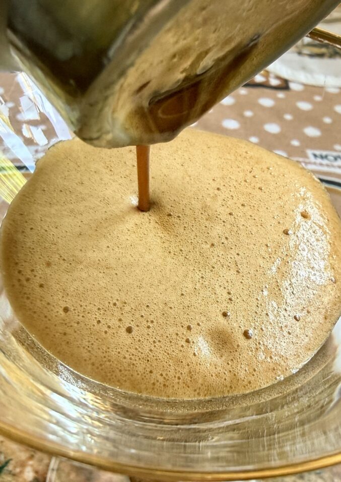 pouring shakerato into a glass