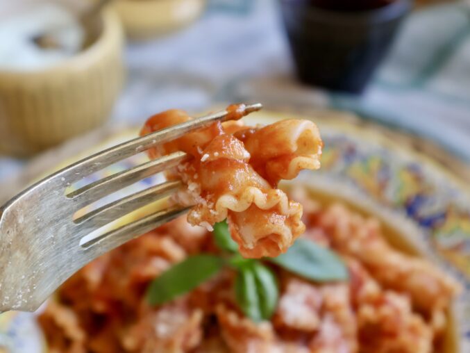 forkful of gigli with wine