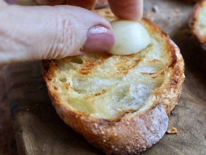 rubbing garlic on toast