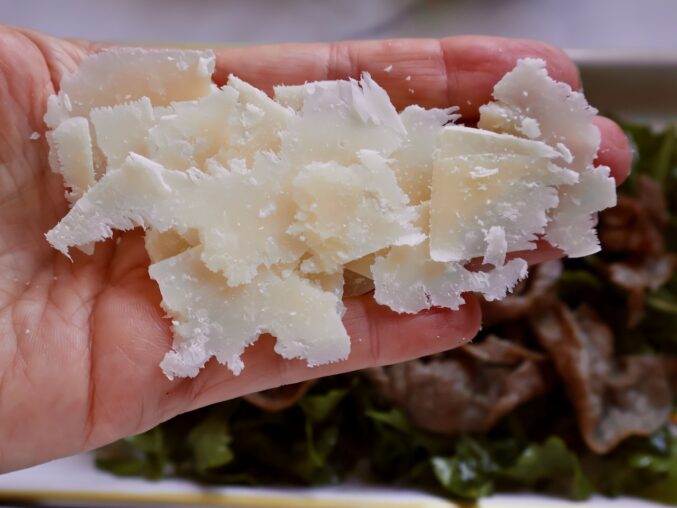 shaved Parmigiano on a hand