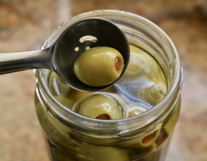 removing olive from jar