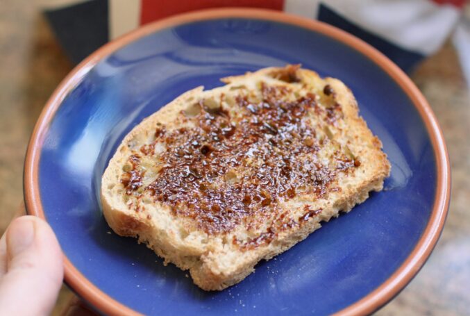 Marmite on toast on blue plate