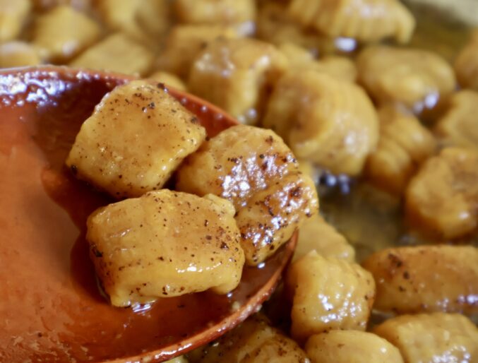 stirring gnocchi and sauce together