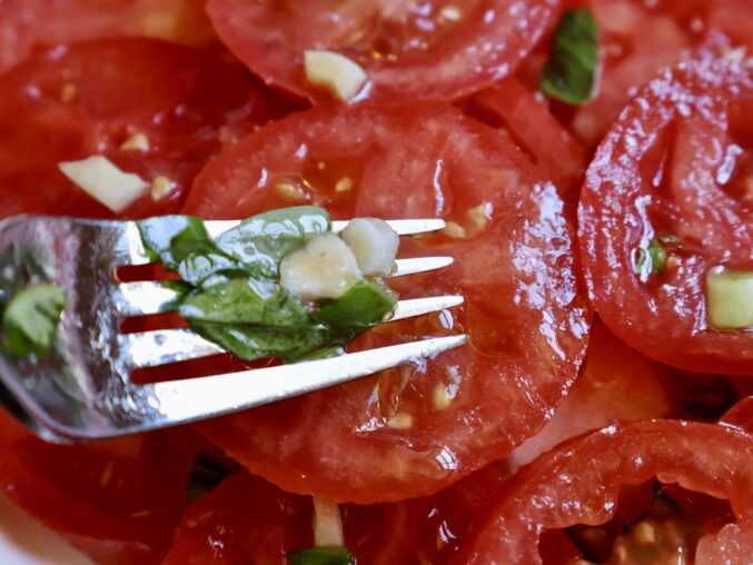 mixing tomato salad